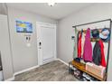 Inviting entryway featuring tile floors, a storage bench, and convenient coat rack at 5942 White Tail Loop, Lakeland, FL 33811