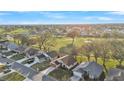 Aerial shot of a residential neighborhood next to a golf course with manicured lawns and mature trees at 6224 Crane Dr, Lakeland, FL 33809