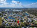 An aerial view showcasing the home's location within a serene community surrounded by lakes and lush greenery at 6271 Res Cir, Lakeland, FL 33810