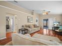 Comfortable living room with wood floors, neutral walls, and sliding glass doors to the outdoors at 6337 Egret Dr, Lakeland, FL 33809