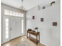 Welcoming foyer with neutral paint, tile flooring, chandelier, and decorative wooden table at 6838 Shimmering Dr, Lakeland, FL 33813