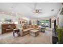 Bright living room featuring neutral carpet, large sectional sofa, and large window with views to the backyard at 6846 Ashbury Dr, Lakeland, FL 33809