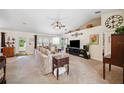 Comfortable living room with a large sectional, ceiling fan, and neutral color palette at 6846 Ashbury Dr, Lakeland, FL 33809