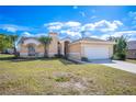 Single-story home with a spacious two-car garage and manicured lawn at 736 Hunt Dr, Lake Wales, FL 33853