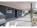 A covered front porch featuring durable concrete flooring and a view of the surrounding neighborhood at 808 Spirit Lake Rd, Winter Haven, FL 33880