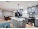 Modern kitchen with sleek gray cabinetry, quartz countertops, and stainless steel appliances at 808 Spirit Lake Rd, Winter Haven, FL 33880