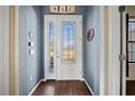 Welcoming foyer with decorative glass door and hardwood floors at 824 Ulmer Rd, Frostproof, FL 33843