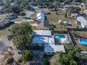 Aerial view of home featuring a backyard swimming pool and lush greenery in a suburban neighborhood at 827 Sherwood Dr, Lake Wales, FL 33898