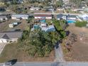 Aerial view of a property featuring a pool, patio, and spacious backyard in a residential neighborhood at 827 Sherwood Dr, Lake Wales, FL 33898