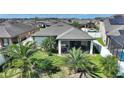 Backyard aerial view featuring a screened-in porch, lush greenery, and a fenced yard at 8718 Rindge Rd, Polk City, FL 33868