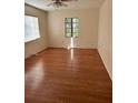 Spacious bedroom featuring laminate flooring, a window for natural light, and neutral walls at 1560 Imperial Ave, Bartow, FL 33830