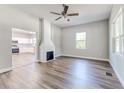 Bright living room with hardwood floors, fireplace, and open access to the kitchen, creating a warm and inviting atmosphere at 22 S Cherokee Ave, Fort Meade, FL 33841