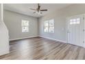 Bright living room featuring beautiful hardwood floors, lots of natural light and views of the front yard at 22 S Cherokee Ave, Fort Meade, FL 33841