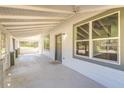 A large, covered porch with a screened-in area featuring a white ceiling and large windows at 22 S Cherokee Ave, Fort Meade, FL 33841