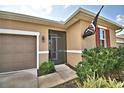 Close up of the front door, front yard and attached two car garage at 300 Lake Smart Cir, Winter Haven, FL 33881