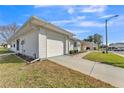 Angle view of a well-maintained single-story home with attached garage and lawn at 3102 Pebble Bend Dr, Lakeland, FL 33810