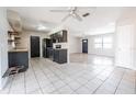 Open-concept kitchen with black appliances, wood countertops, tile floor and plenty of light at 320 E Daughtery Rd, Lakeland, FL 33809