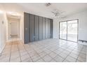 Bright, tiled living area with sliding glass door access to a screened porch at 320 E Daughtery Rd, Lakeland, FL 33809