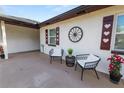 Inviting front patio featuring comfortable seating and charming decorative details at 327 Corona Del Mar St, Lakeland, FL 33809