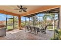 Relaxing screened patio with brick flooring, a ceiling fan, comfortable seating, and outdoor plants at 3978 Viamonte Ln, Lakeland, FL 33810