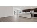 Bright, open-concept space featuring a modern kitchen with stainless steel appliances and an island at 4522 Rapallo Ave, Winter Haven, FL 33884