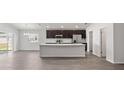 Open floor plan featuring a kitchen with stainless steel appliances and a large island with bar seating at 4522 Rapallo Ave, Winter Haven, FL 33884
