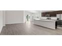 Open floor plan showing stainless steel appliances, ample counter space, and a seamless transition to the living area at 4522 Rapallo Ave, Winter Haven, FL 33884