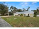 Beautiful single story home featuring lush green lawn, landscaping, and a sturdy metal roof at 4550 Old Colony Rd, Mulberry, FL 33860