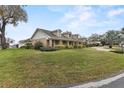 A well-maintained lawn, mature trees, and manicured shrubs complement this attractive home at 4624 Kings Point Ct, Lakeland, FL 33813