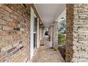 Covered porch with brick and stone columns leads to the front door, offering shade and architectural detail at 4624 Kings Point Ct, Lakeland, FL 33813