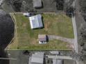 Aerial view of the property with a well-maintained lawn, a metal roof, and a detached two-car garage at 5418 Cooper Ln, Fort Meade, FL 33841