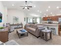 Spacious living room open to the kitchen and dining area, featuring modern furnishings and decor at 5443 Se 127Th Ln, Belleview, FL 34420