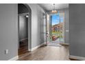 Open entryway with wood flooring, modern light fixture, and view to the home's front exterior at 5623 Superior Dr, Lakeland, FL 33805