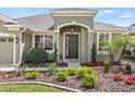 Attractive entryway with a dark front door, manicured landscaping, and well-maintained lawn at 5623 Superior Dr, Lakeland, FL 33805