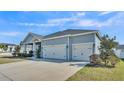 Spacious three-car garage offers ample parking and storage, complementing this home's appealing exterior at 5806 Valentino Way, Lakeland, FL 33812