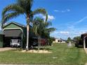 Lush green lawn features verdant landscaping and irrigation for the well-manicured yard at 585 Meandering Way, Polk City, FL 33868