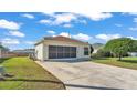 A well-maintained home with a large driveway and attached garage, surrounded by green lawns at 6193 Magpie Dr, Lakeland, FL 33809