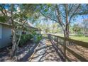 Exterior view of the home featuring a long driveway and large fenced yard, perfect for outdoor activities at 6615 Broken Arrow S Trl, Lakeland, FL 33813