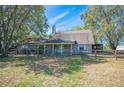 Charming ranch-style home featuring a fenced yard and mature trees, creating a welcoming curb appeal at 6615 Broken Arrow S Trl, Lakeland, FL 33813