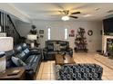 Cozy living room with tile flooring, comfortable seating, and a ceiling fan at 6615 Broken Arrow S Trl, Lakeland, FL 33813