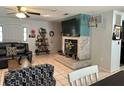 Bright living room showcases a stone fireplace with mantel, tile flooring, and comfortable seating at 6615 Broken Arrow S Trl, Lakeland, FL 33813