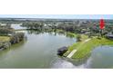 Breathtaking aerial view of a lakefront property with private dock, highlighting its serene setting at 7410 Locksley Ln, Lakeland, FL 33809