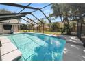 Inviting screened-in pool with crystal-clear water, surrounded by a spacious patio area at 7410 Locksley Ln, Lakeland, FL 33809
