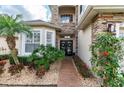 Beautiful home entrance showcasing stone accents, lush landscaping, double doors, and a brick pathway at 794 Lake Clark Ct, Lakeland, FL 33813