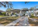 Beautiful craftsman style home with large porch and brick paved driveway leading to garage at 815 Success Ave, Lakeland, FL 33801