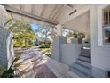 Covered front porch with brick pillars, steps and view of the street at 815 Success Ave, Lakeland, FL 33801