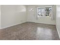 Bright living room with neutral paint, a large window, and durable flooring at 144 Lowell Rd, Winter Haven, FL 33884