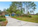 View of the front exterior showing the long driveway leading up to the home at 15 Tera Ln, Winter Haven, FL 33880