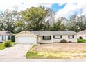 Charming single-story home with a well-manicured lawn and attached two-car garage at 1548 Churchill Ct, Lakeland, FL 33801