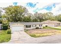 Charming single-story home with a well-manicured lawn and attached two-car garage at 1548 Churchill Ct, Lakeland, FL 33801